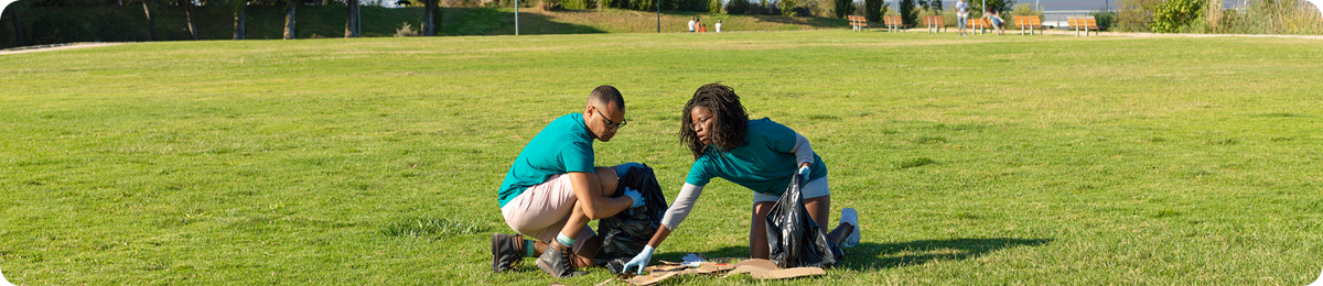Two people installing artificial grass