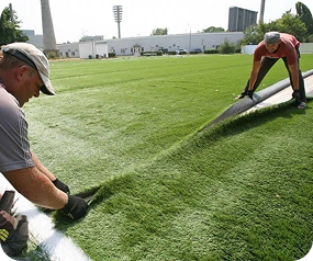 Installing artificial grass on sports field